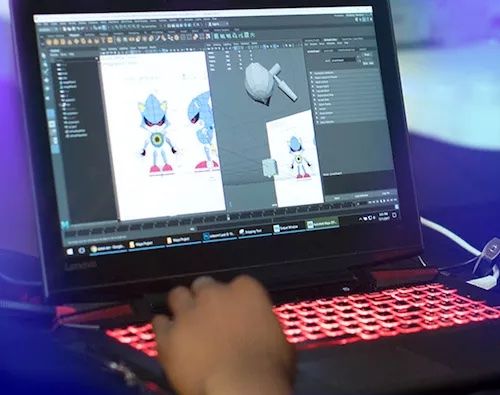 3d modeling video game character on laptop