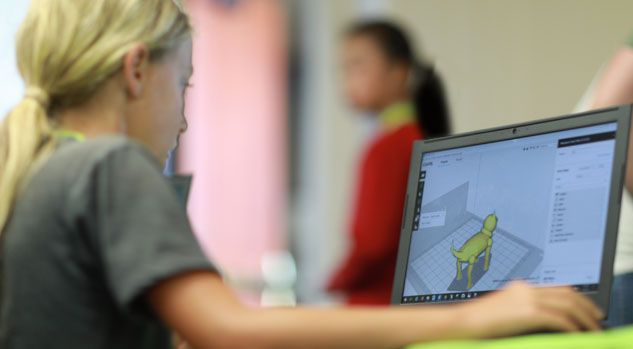 girl looking at laptop working on blender model