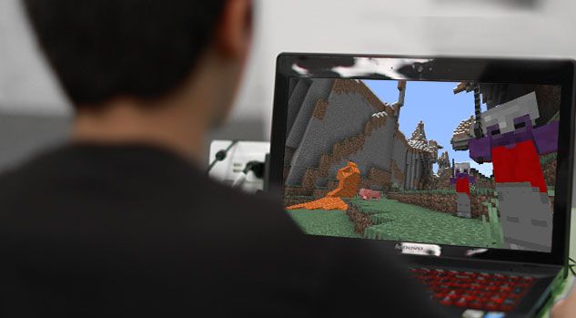 over the shoulder of boy working on minecraft project
