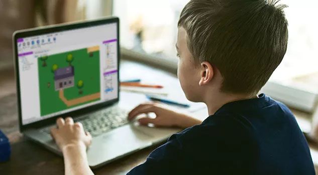boy at computer building a video game