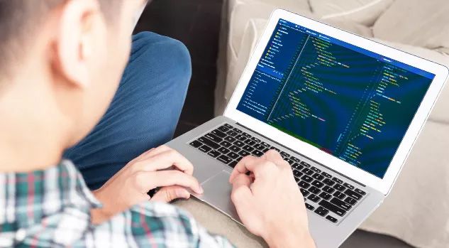 boy working on laptop with html