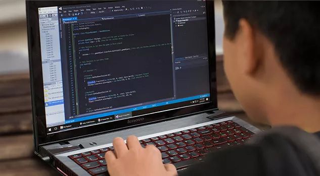 boy working on laptop with javascript