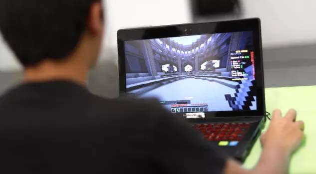 boy at laptop with minecraft 