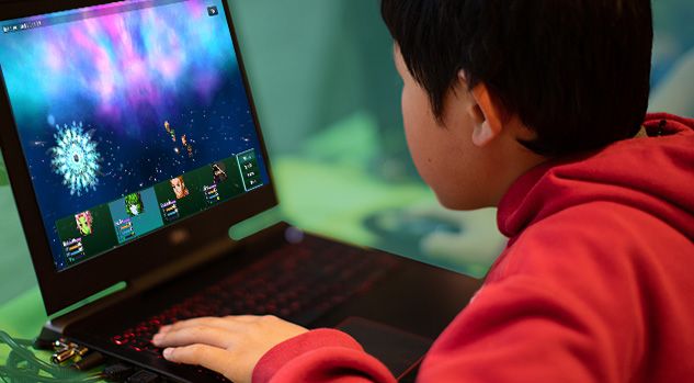 boy looking at laptop with rpg maker