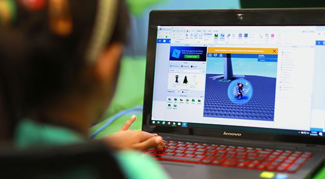 child working on roblox studio project